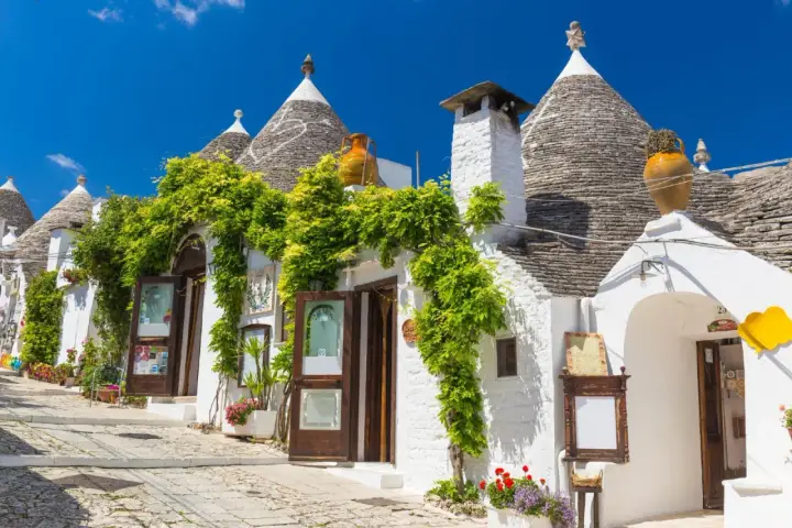 Trulli bianchi fioriti in Puglia, un'atmosfera magica per il 25 aprile.